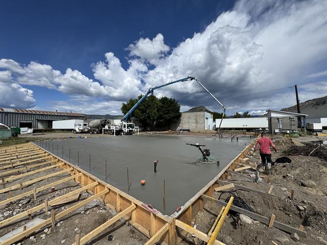 Concrete slab being poured with a boom pump truck